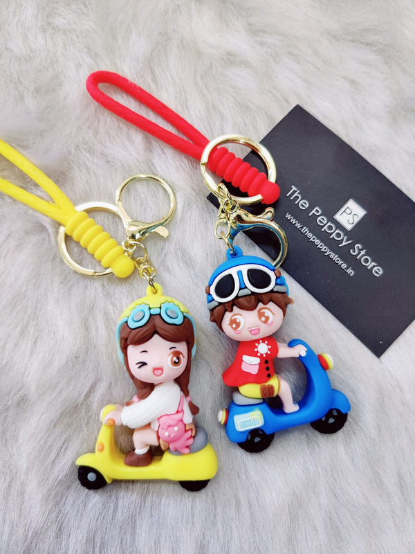 Cute Boy and Girl On Scooty Couple Keychain With Bagcharm and Strap (Set Of 2)