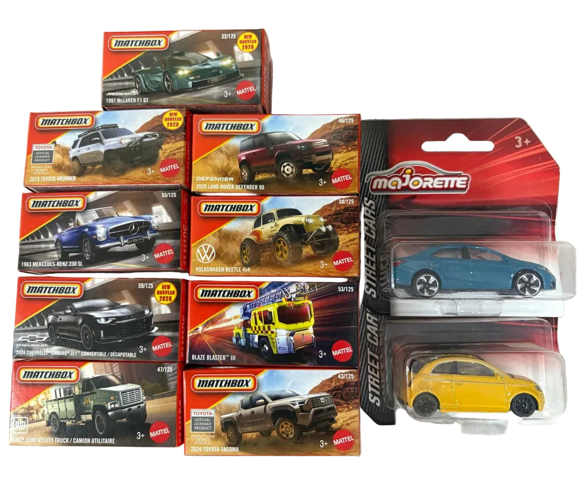 Collection of Matchbox and Majorette toy car boxes on a textured surface